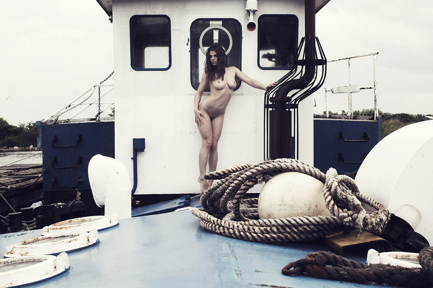 fine art nude of a woman on a boat