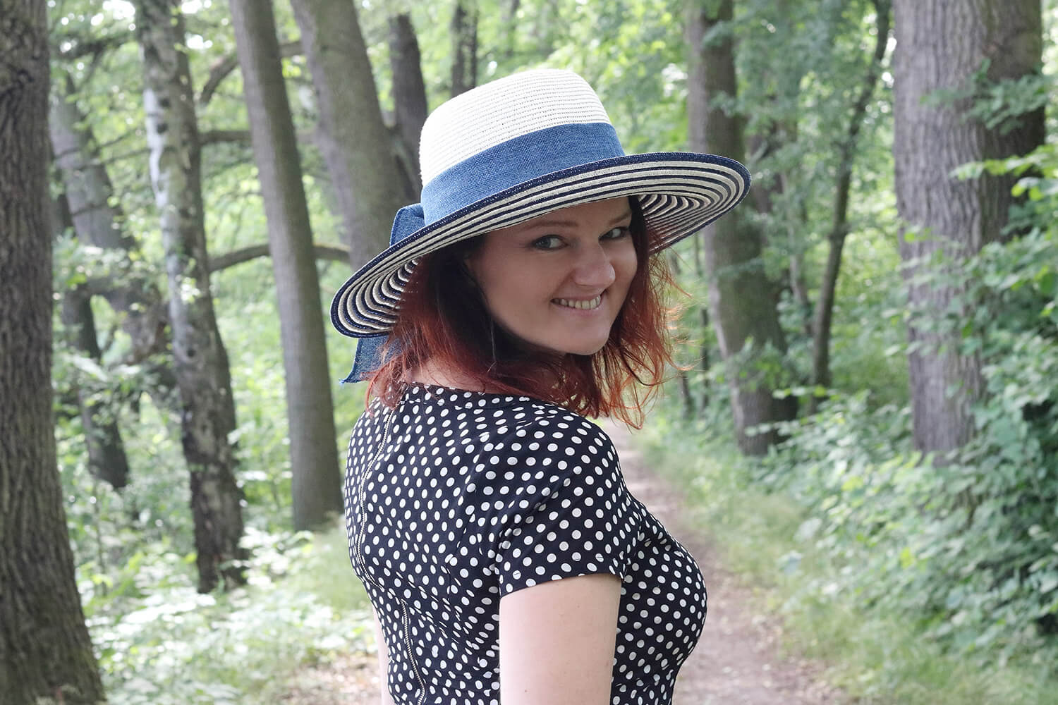 portrait of a woman with a hat in nature