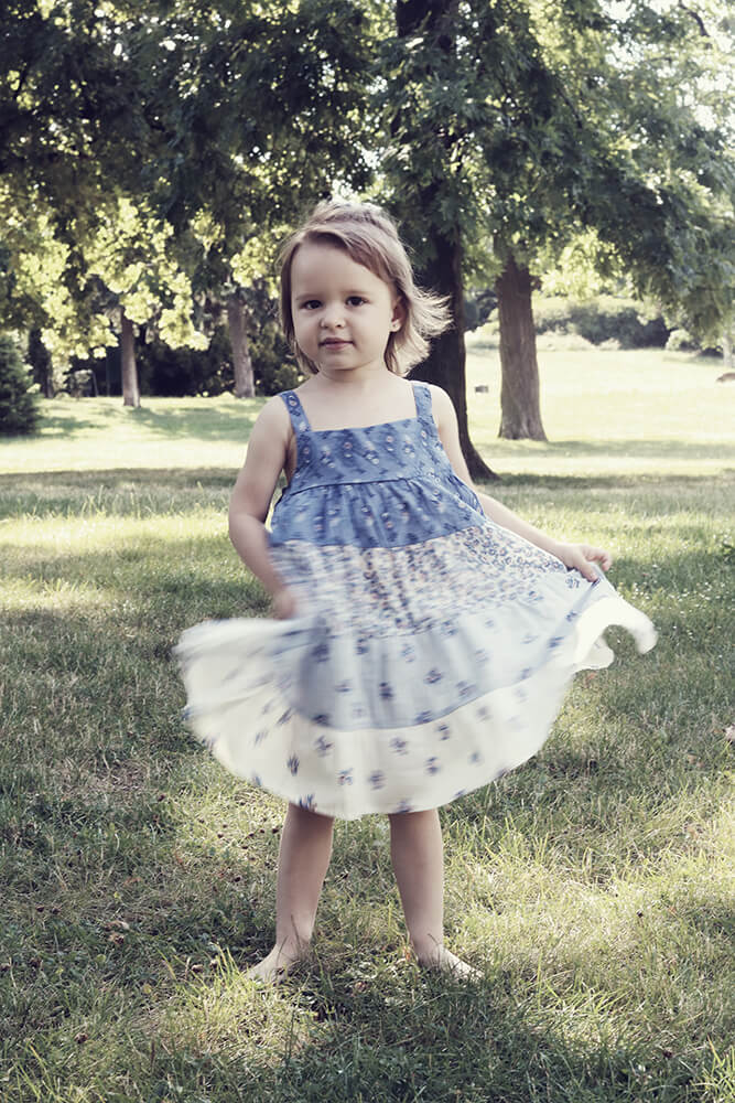 family photo of a little girl in a dress in the park