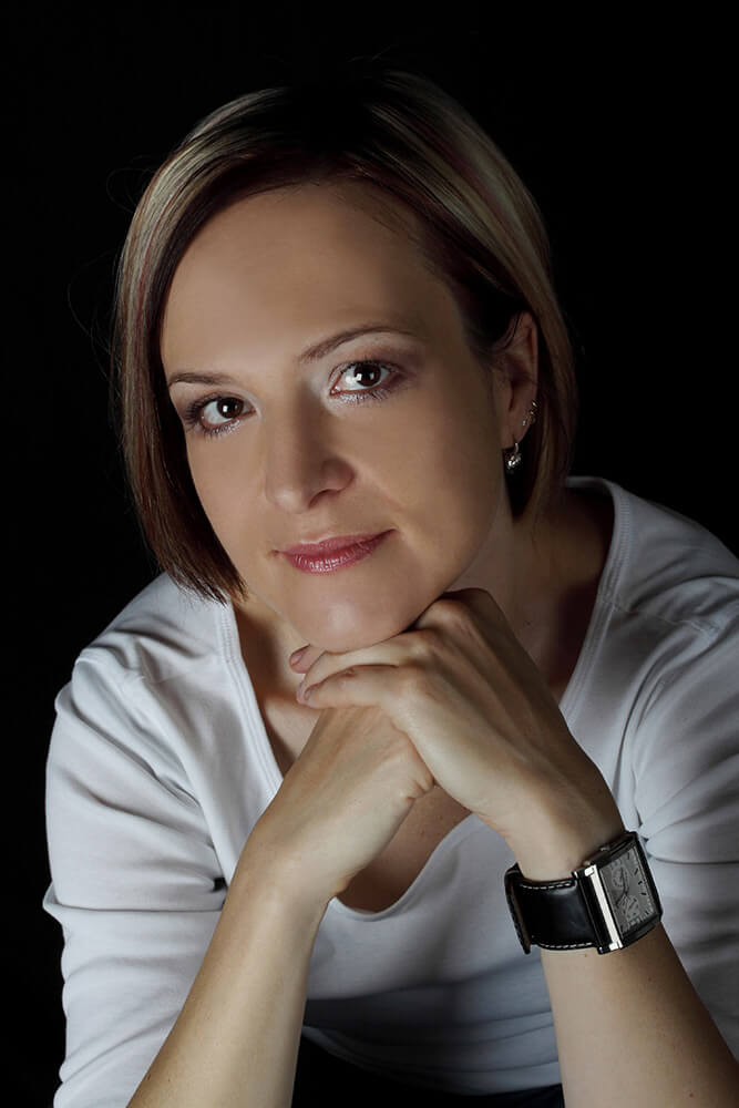 female business portrait in white t-shirt on black background