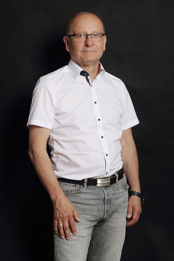male business portrait in a white shirt on a dark background